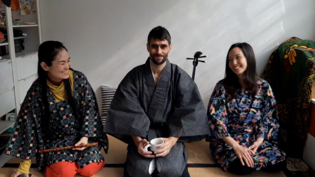 Me and two women sitting on tatami, holding tea cups