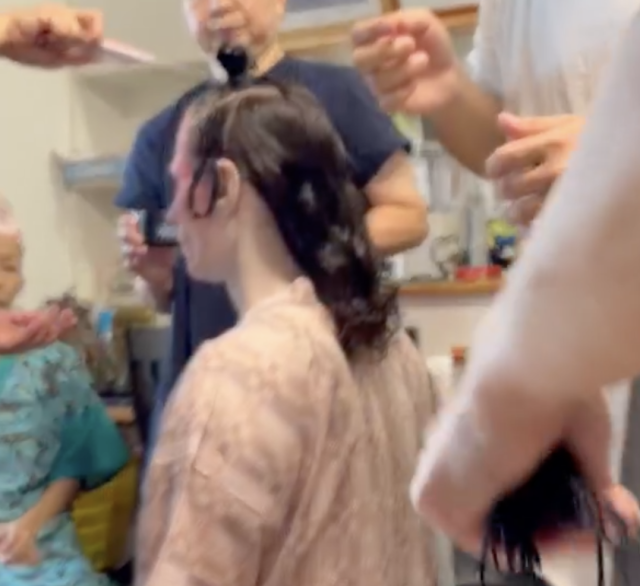 People standing around me and doing my hair People standing around me and doing my hair